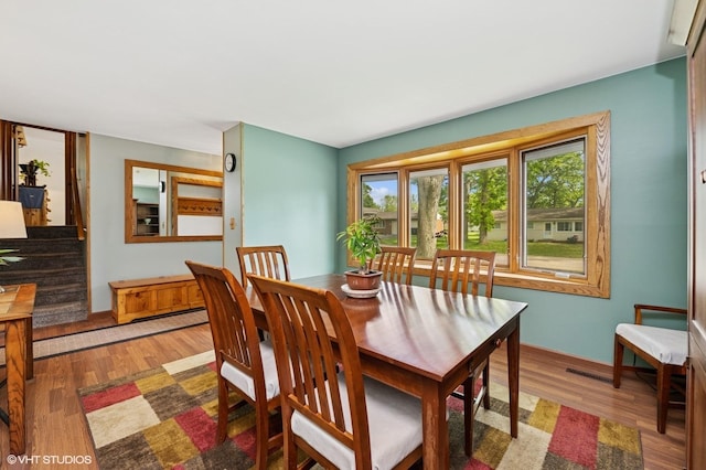 7404 Wooded Shore Dr, Wonder Lake, IL 60097 - dining area with wood finished floors and stairs