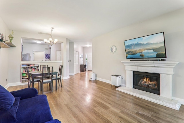 3032 Kentshire Cir, Naperville, IL 60564 - living room featuring wood finished floors, a chandelier, and a fireplace