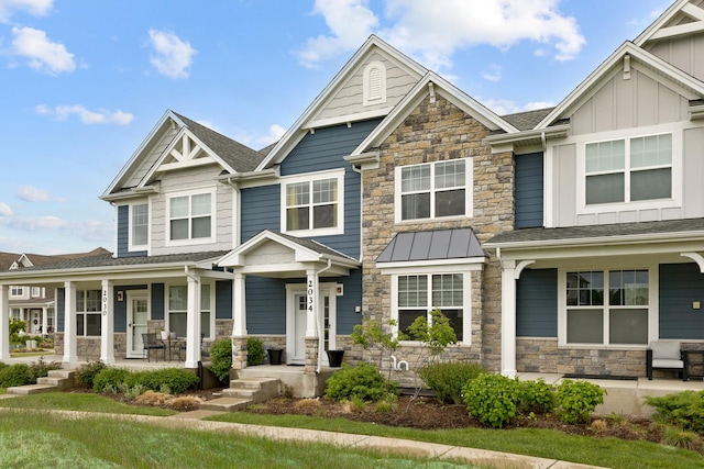 2034 Link Dr, Buffalo Grove, IL 60089 - view of front of house with a porch, stone siding, and board and batten siding