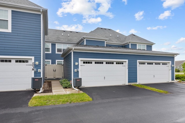 2034 Link Dr, Buffalo Grove, IL 60089 - view of front of house with central AC, a gate, ac unit, and driveway
