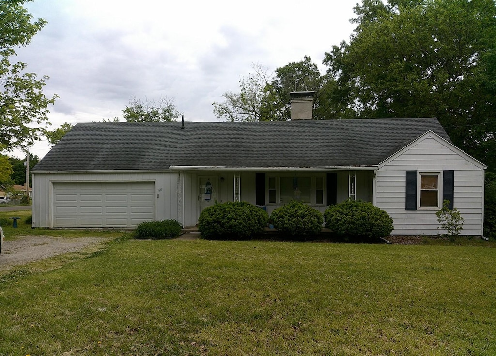1511 N Logan Ave, Danville, IL 61832 - ranch-style home featuring a chimney, dirt driveway, a garage, and a front yard