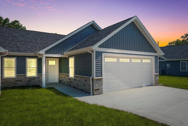 207 E Fairfield St, Fisher, IL 61843 - view of front of house with board and batten siding, stone siding, roof with shingles, a garage, and concrete driveway