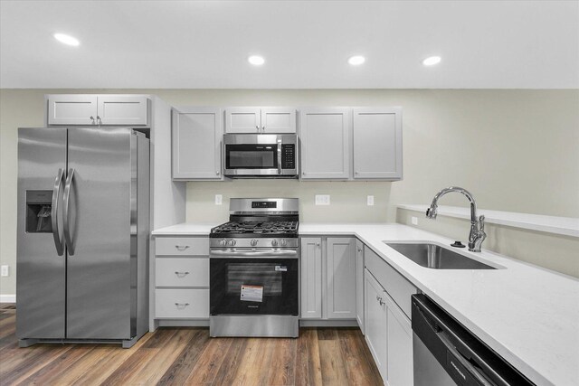 207 E Fairfield St, Fisher, IL 61843 - kitchen with appliances with stainless steel finishes, a sink, light countertops, recessed lighting, and dark wood-type flooring