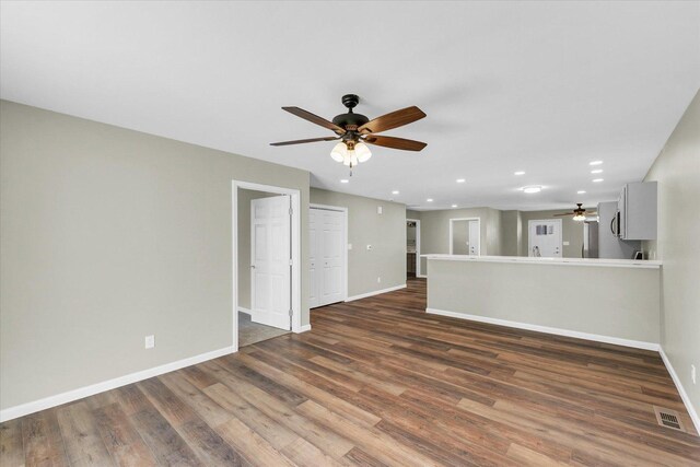 207 E Fairfield St, Fisher, IL 61843 - unfurnished living room with a ceiling fan, baseboards, wood finished floors, and recessed lighting