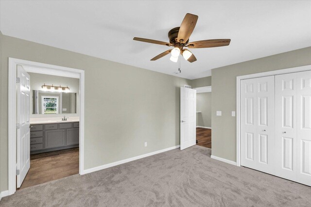 207 E Fairfield St, Fisher, IL 61843 - unfurnished bedroom featuring carpet, baseboards, a closet, a sink, and connected bathroom