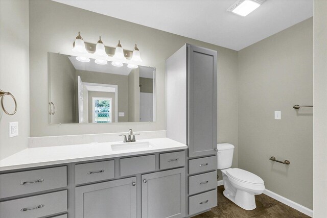 207 E Fairfield St, Fisher, IL 61843 - bathroom featuring toilet, vanity, and baseboards