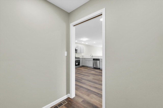 207 E Fairfield St, Fisher, IL 61843 - hallway featuring a sink, dark wood finished floors, and baseboards