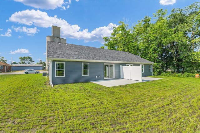 207 E Fairfield St, Fisher, IL 61843 - rear view of house with a patio, a lawn, and a chimney