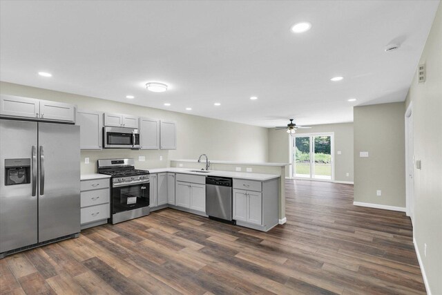 207 E Fairfield St, Fisher, IL 61843 - kitchen featuring appliances with stainless steel finishes, gray cabinetry, a peninsula, dark wood-style flooring, and light countertops