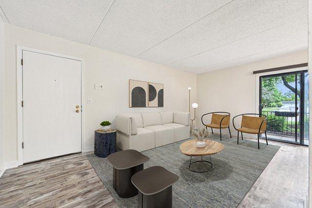 1221 Chalet Rd Unit 101, Naperville, IL 60563 - living area featuring wood finished floors and a textured ceiling