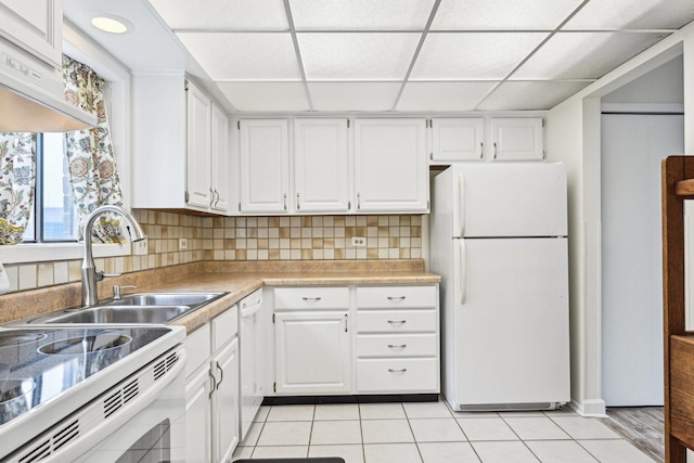 1221 Chalet Rd Unit 101, Naperville, IL 60563 - kitchen featuring white appliances, white cabinets, decorative backsplash, light tile patterned floors, and a sink