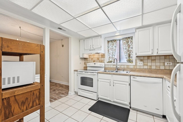 1221 Chalet Rd Unit 101, Naperville, IL 60563 - kitchen with white appliances, a sink, under cabinet range hood, white cabinets, and light countertops