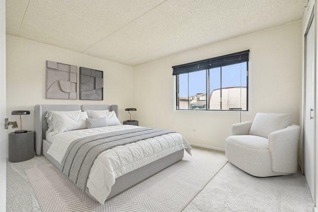 1221 Chalet Rd Unit 101, Naperville, IL 60563 - bedroom with carpet, a textured ceiling, and baseboards