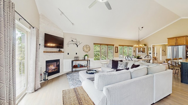 5816 Wild Plum Rd, Crystal Lake, IL 60014 - living area featuring light wood finished floors, a fireplace, high vaulted ceiling, a ceiling fan, and a chandelier
