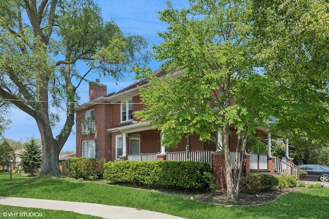 8534 Terminal Ave, Skokie, IL 60077 - view of side of property with brick siding, a chimney, a yard, and a porch