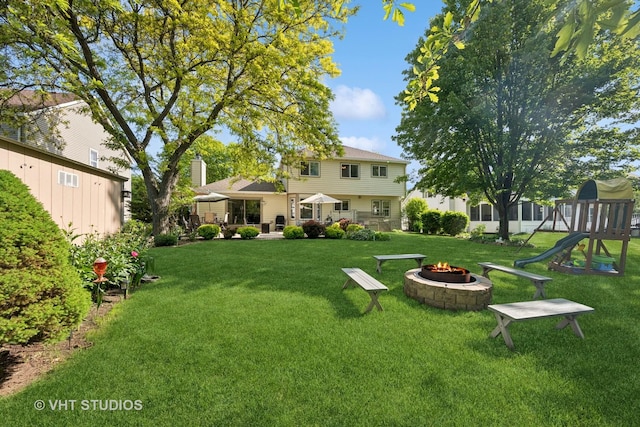 1149 Saddle Ridge Trl, Cary, IL 60013 - view of grassy yard featuring an outdoor fire pit and a playground