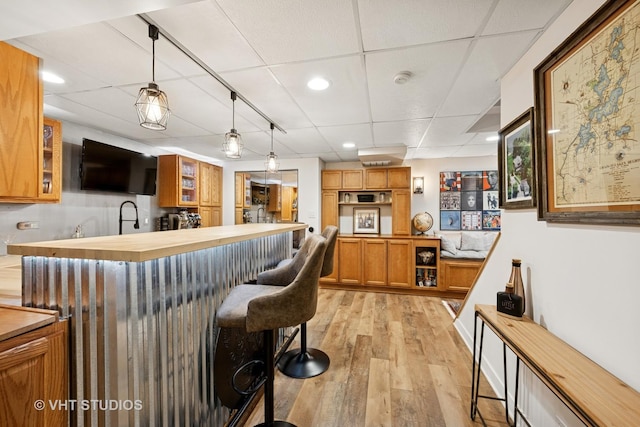 1149 Saddle Ridge Trl, Cary, IL 60013 - kitchen with butcher block countertops, a breakfast bar, a paneled ceiling, light wood-type flooring, and recessed lighting