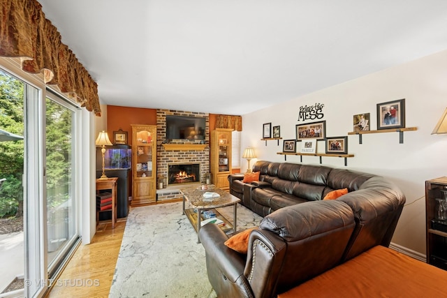 1149 Saddle Ridge Trl, Cary, IL 60013 - living area featuring light wood-style flooring and a brick fireplace