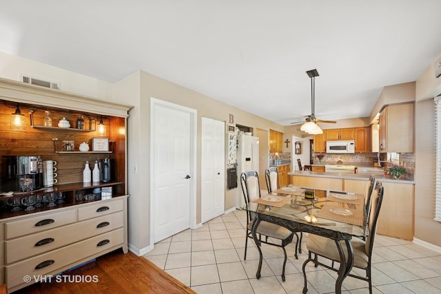 1149 Saddle Ridge Trl, Cary, IL 60013 - dining area with light tile patterned flooring, baseboards, and a ceiling fan