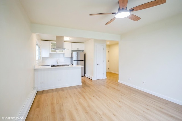 8880 Golf Rd Unit 1H, Des Plaines, IL 60016 - kitchen with freestanding refrigerator, white cabinetry, light wood-style flooring, a peninsula, and ventilation hood