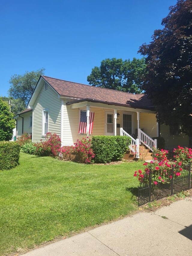 1006 N Park St, Streator, IL 61364 - view of property exterior with a yard, covered porch, and a shingled roof
