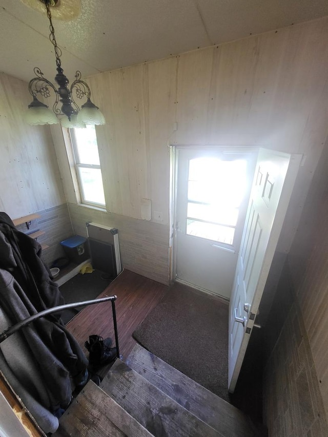 1006 N Park St, Streator, IL 61364 - stairway with wood finished floors, a chandelier, and radiator heating unit