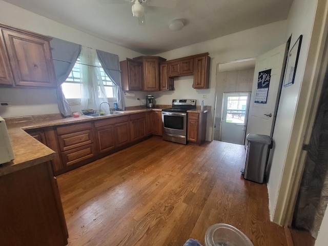 1006 N Park St, Streator, IL 61364 - kitchen with electric stove, ceiling fan, wood finished floors, and brown cabinets