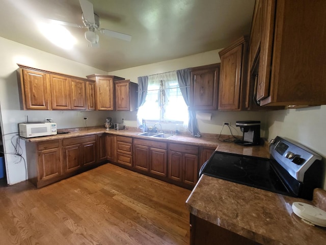 1006 N Park St, Streator, IL 61364 - kitchen featuring electric range, white microwave, a sink, wood finished floors, and brown cabinetry