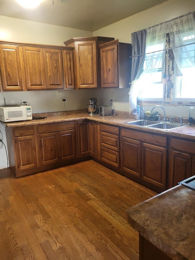 1006 N Park St, Streator, IL 61364 - kitchen with white microwave, dark wood-style flooring, and brown cabinets