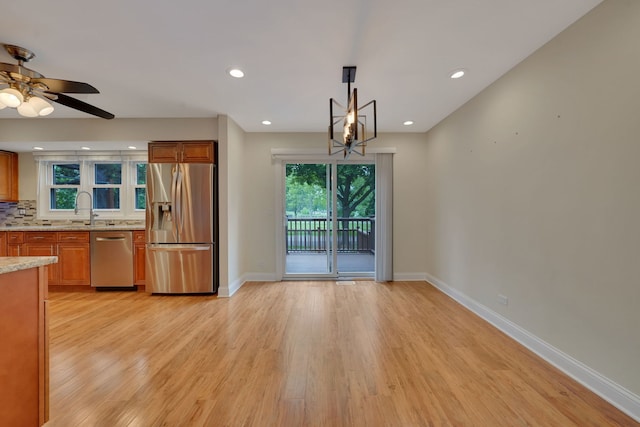 208 Spring Ct, Bloomingdale, IL 60108 - kitchen with appliances with stainless steel finishes, a ceiling fan, light wood-type flooring, light stone countertops, and recessed lighting