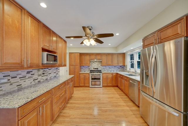 208 Spring Ct, Bloomingdale, IL 60108 - kitchen with stainless steel appliances, light wood-type flooring, decorative backsplash, light stone countertops, and brown cabinets