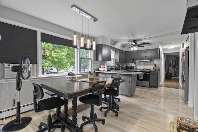 6004 S Keeler Ave, Chicago, IL 60629 - dining space with ceiling fan, light wood finished floors, and a baseboard heating unit