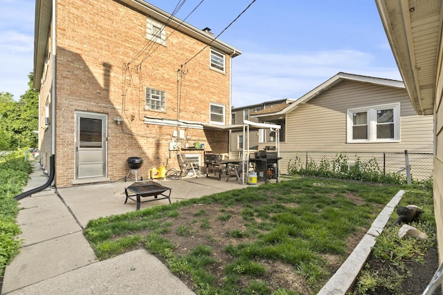 6004 S Keeler Ave, Chicago, IL 60629 - rear view of property featuring brick siding, a fire pit, and a patio