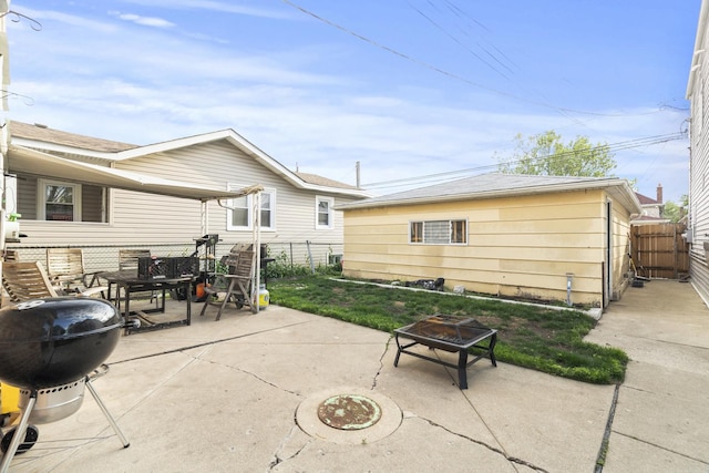 6004 S Keeler Ave, Chicago, IL 60629 - fenced backyard with an outdoor fire pit, a patio area, grilling area, and outdoor dining area