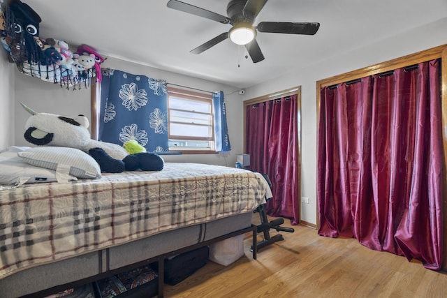 6004 S Keeler Ave, Chicago, IL 60629 - bedroom featuring wood finished floors, multiple closets, ceiling fan, and baseboards