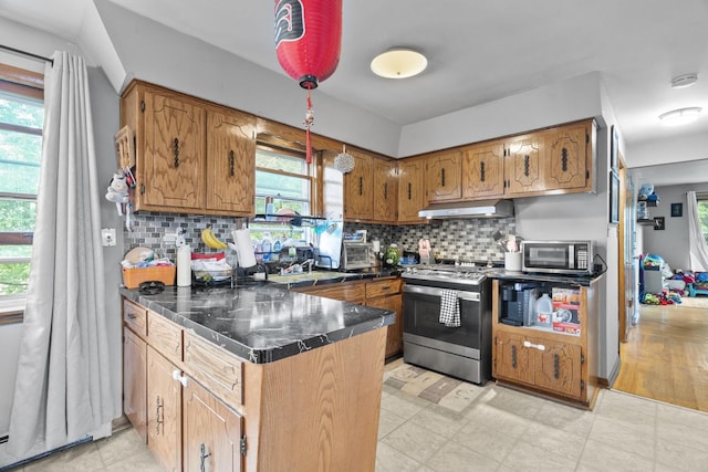 6004 S Keeler Ave, Chicago, IL 60629 - kitchen with appliances with stainless steel finishes, a peninsula, brown cabinetry, and healthy amount of natural light