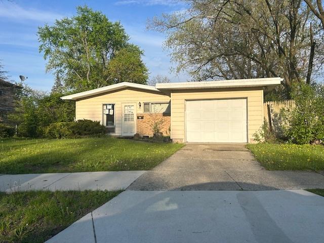 323 Windsor St, Park Forest, IL 60466 - ranch-style home with an attached garage, driveway, and a front lawn