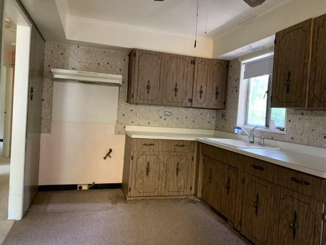 323 Windsor St, Park Forest, IL 60466 - kitchen featuring light countertops, decorative backsplash, a sink, and baseboards