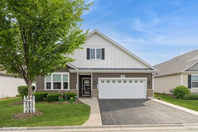 1033 Carolina Ct, Pingree Grove, IL 60140 - view of front facade with board and batten siding, brick siding, driveway, a garage, and a front lawn