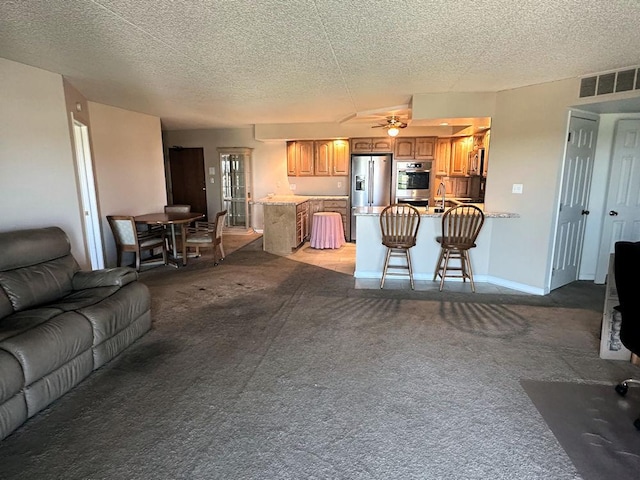 1133 N 7th St Unit 806, Rochelle, IL 61068 - living area featuring light carpet, ceiling fan, a textured ceiling, and baseboards