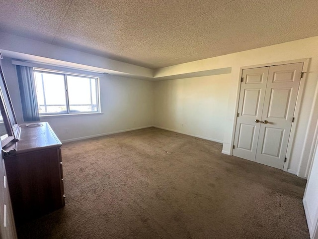 1133 N 7th St Unit 806, Rochelle, IL 61068 - unfurnished bedroom with carpet flooring, baseboards, a textured ceiling, and a closet