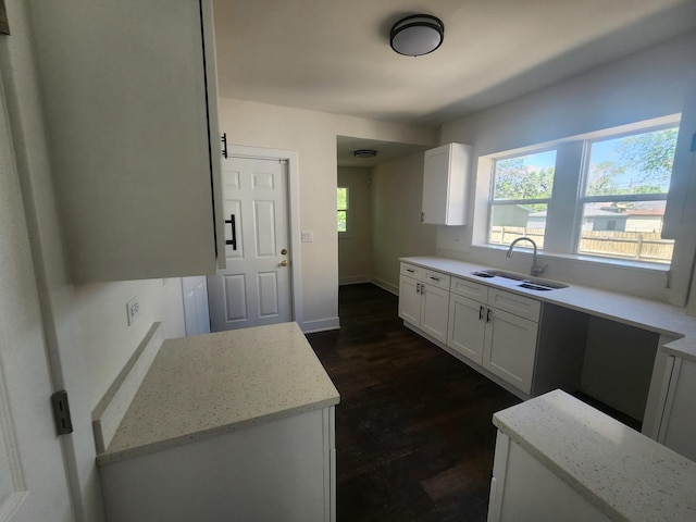 12416 S Carpenter St, Calumet Park, IL 60827 - kitchen with a sink, light stone counters, white cabinetry, dark wood finished floors, and baseboards
