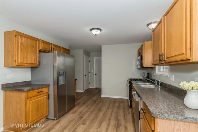 25785 W Hillside Ave, Ingleside, IL 60041 - kitchen featuring appliances with stainless steel finishes, light wood-style floors, baseboards, and dark countertops