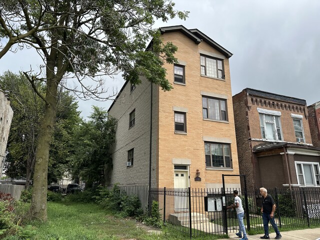 4316 W Gladys Ave, Chicago, IL 60624 - view of building exterior featuring a fenced front yard