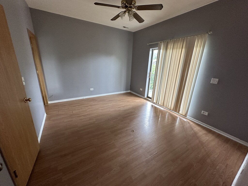 4316 W Gladys Ave, Chicago, IL 60624 - spare room with a ceiling fan, wood finished floors, and baseboards