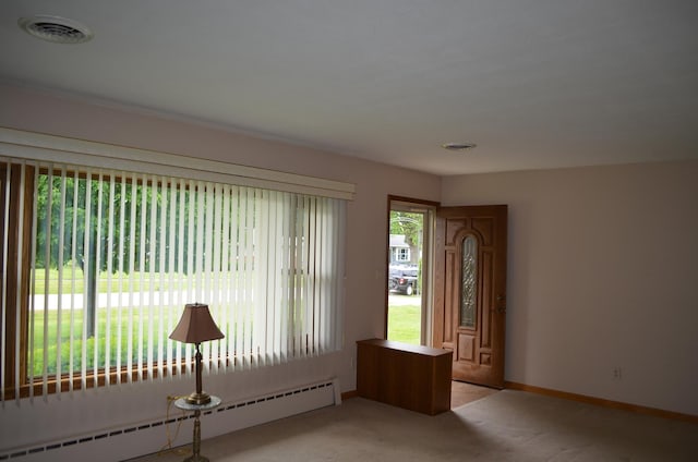 3127 Jo Ann Dr, Joliet, IL 60431 - foyer entrance with a baseboard radiator, light colored carpet, and baseboards