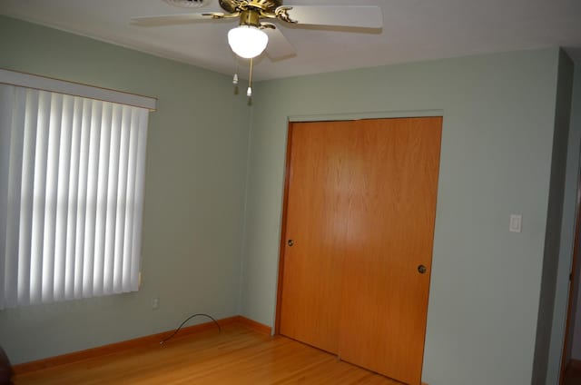 3127 Jo Ann Dr, Joliet, IL 60431 - unfurnished bedroom with wood finished floors, a closet, baseboards, and a ceiling fan