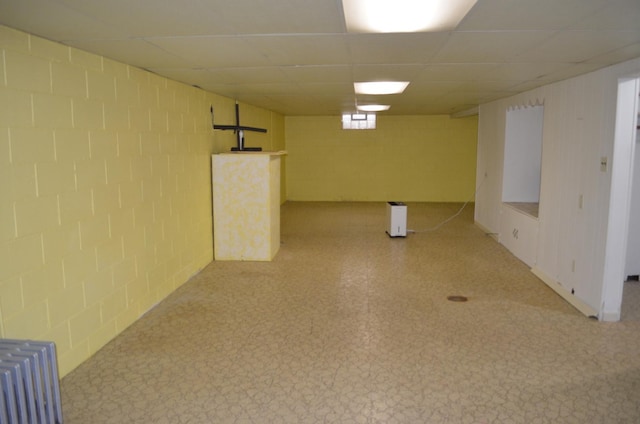 3127 Jo Ann Dr, Joliet, IL 60431 - below grade area with radiator heating unit, light flooring, concrete block wall, and a paneled ceiling