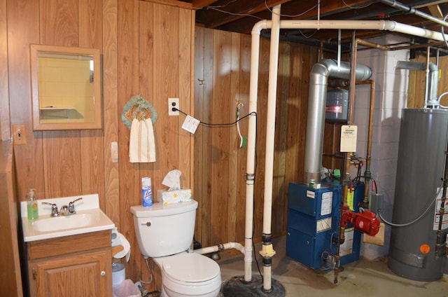 3127 Jo Ann Dr, Joliet, IL 60431 - bathroom with water heater, vanity, wood walls, toilet, and concrete flooring