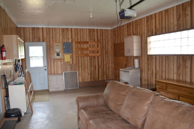 3127 Jo Ann Dr, Joliet, IL 60431 - living area featuring finished concrete floors, wood walls, electric panel, and ornamental molding